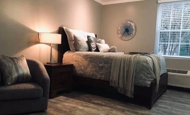 Cozy private resident room with a bed and chair