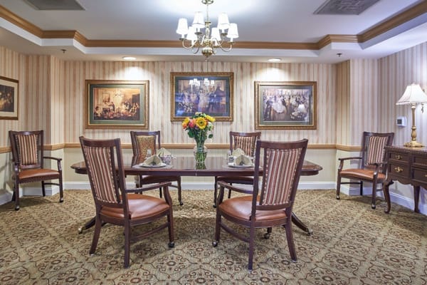 Dining room with tables and chairs set for meals.