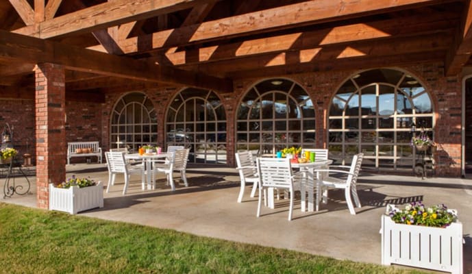 Outdoor seating area with tables and flowers