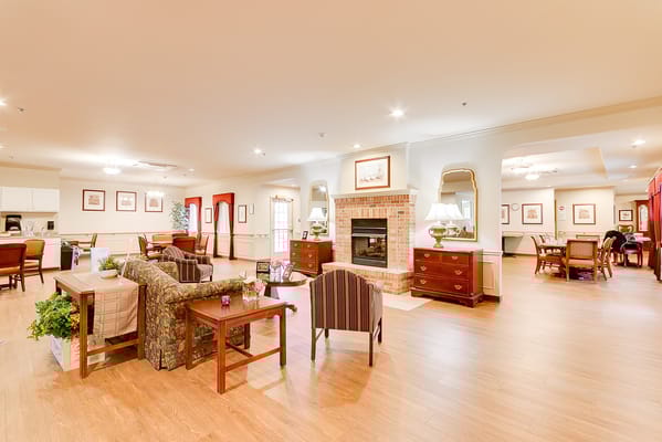 Bright common area with seating and a fireplace