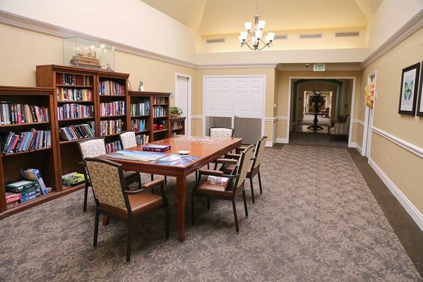 Interior view of a common area with bookshelves and a table