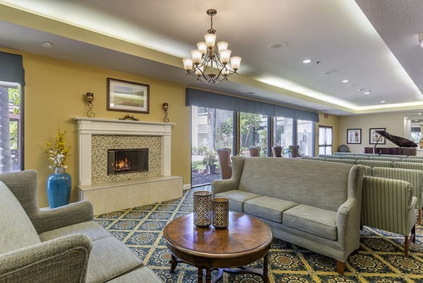 Bright common area with comfortable seating and fireplace