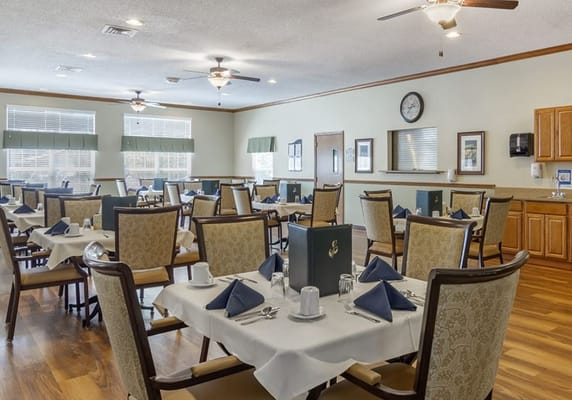 Dining area set up for a meal service with tables and chairs