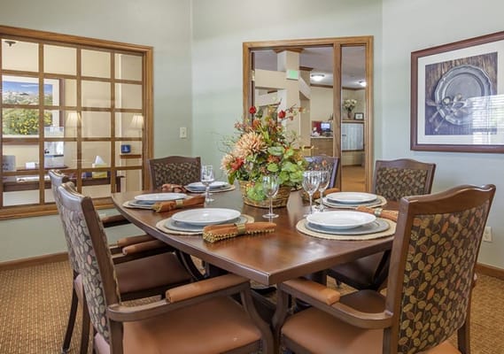 Dining room set for a meal with floral centerpiece