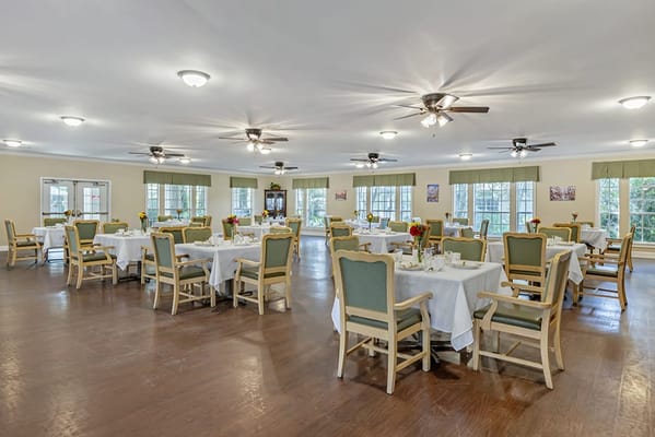 Bright dining room with tables set for meals