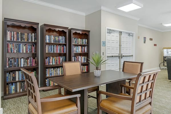 Interior of a common area with bookshelves and a table