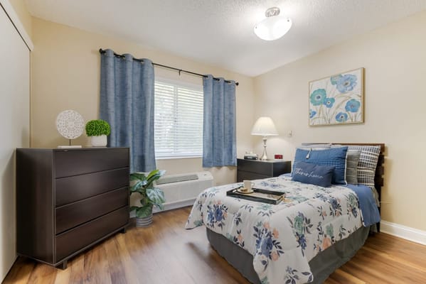 Cozy resident bedroom with floral bedding and decor