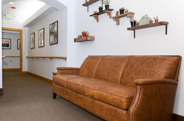 A cozy seating area in a hallway with plants