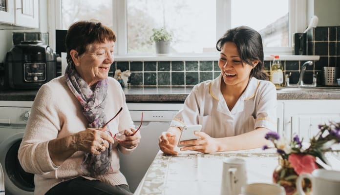 Caregiver and resident enjoying a conversation in the kitchen