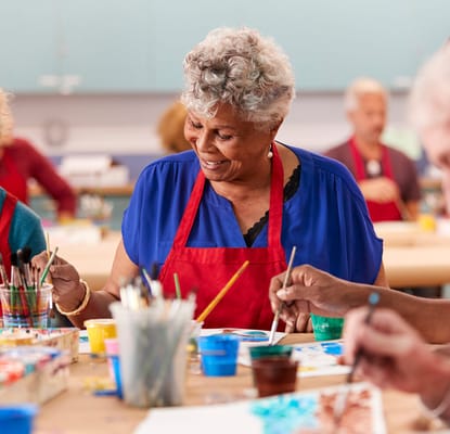 Residents painting in an activity room