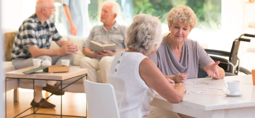 Residents engaged in a group activity inside the facility