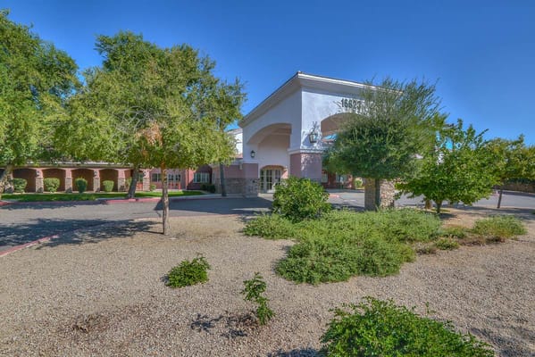 Exterior view of a senior living facility with landscaping