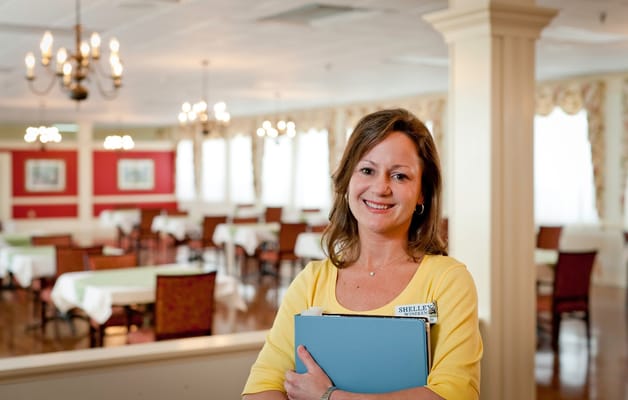 Staff member in dining area of the facility