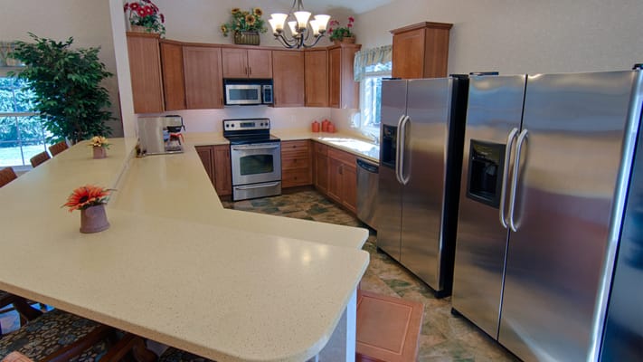 Bright and spacious kitchen with wooden cabinets and stainless steel appliances