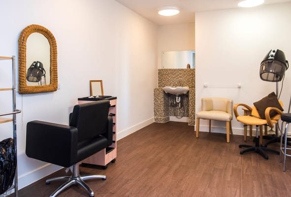 Interior view of a beauty salon with chairs and mirrors
