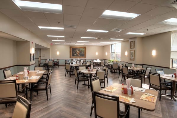 Dining room with tables and chairs, prepared for meals