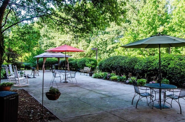 Outdoor patio area with seating and umbrellas