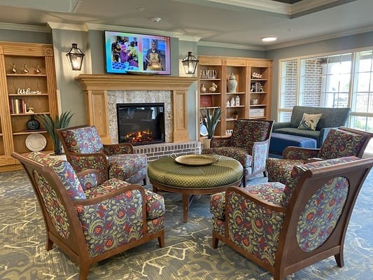 Cozy interior common area with seating and a fireplace