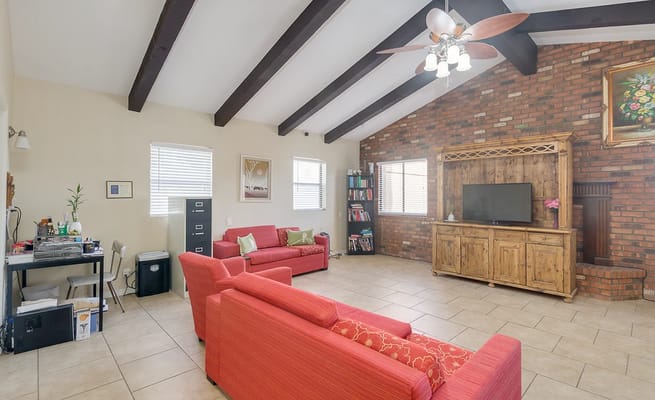 Bright interior lounge area with seating and bookshelf