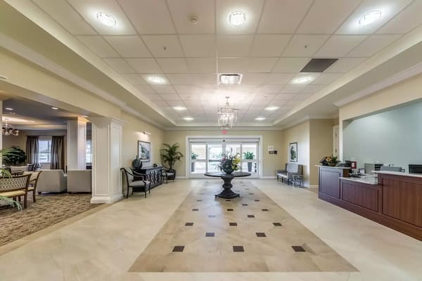 Bright lobby area with seating and floral arrangement