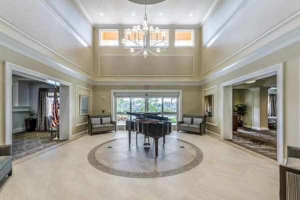 Spacious common area with a grand piano and seating