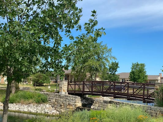 Beautiful outdoor space with a wooden bridge and landscaped area