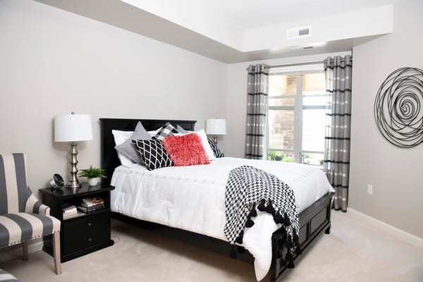 Brightly decorated resident room with a bed and seating