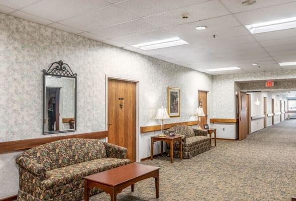 Interior hallway with couches and wall decor