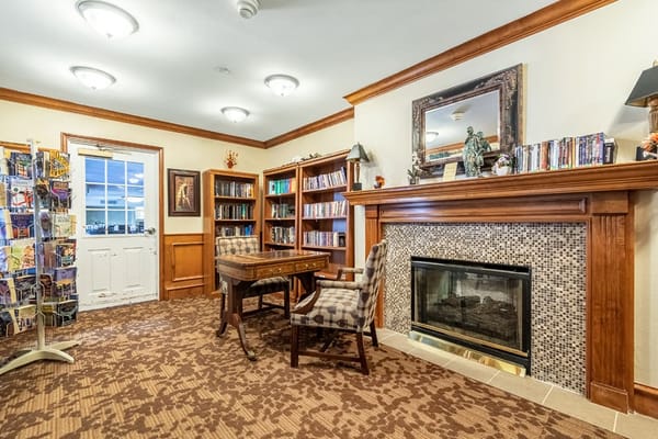 Cozy library area with a fireplace and bookshelves