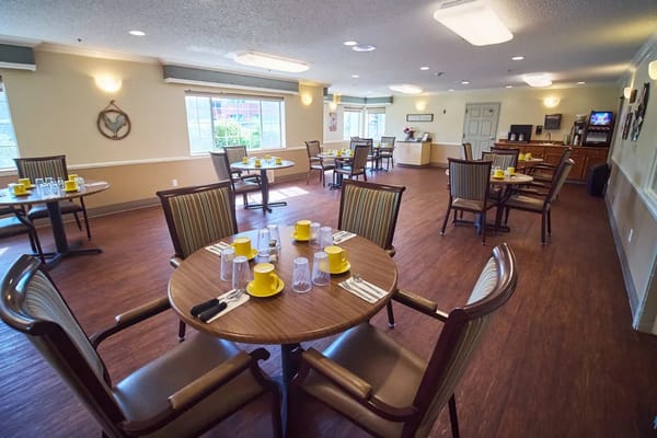 Dining room setup with yellow dishes and silverware