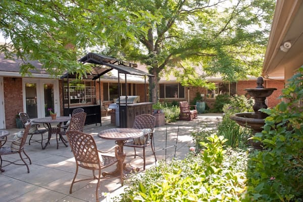 Outdoor patio area with seating and greenery