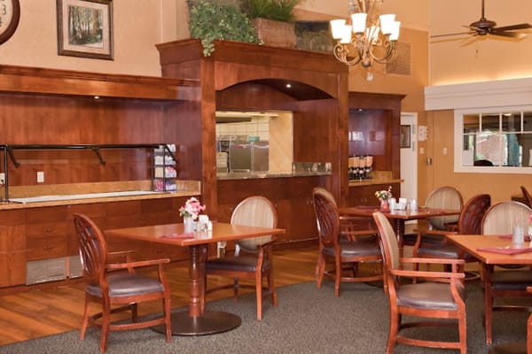 Dining area with tables and chairs in warm tones