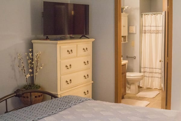 Comfortable resident room with a TV and bathroom