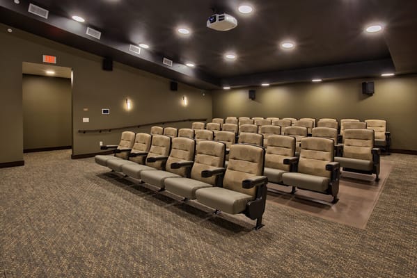 Interior view of a cinema-style theater with plush seating