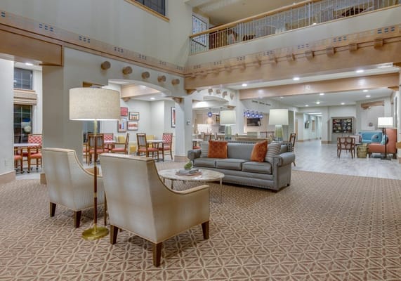 Common area with seating and decor in a senior living facility