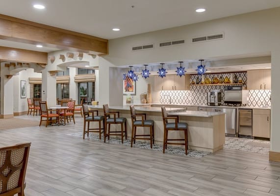 Bright and inviting common area with seating and bar