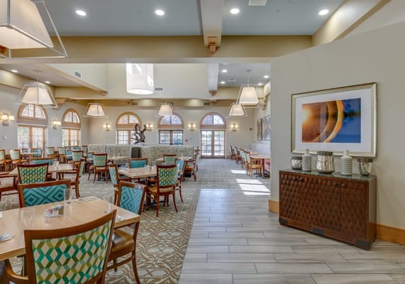 Bright dining room with tables and seating for residents
