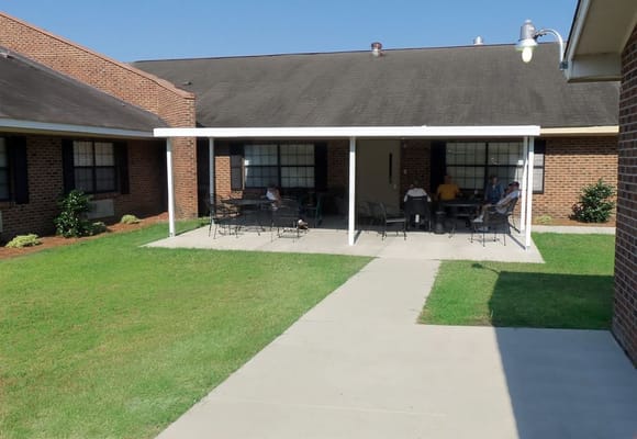 Residents enjoying time on the patio at Fayetteville Manor