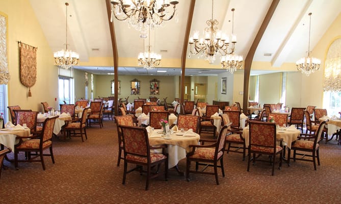 Spacious dining area with chandeliers and beautifully set tables