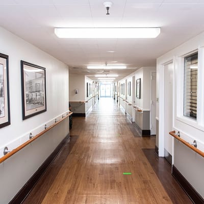 A well-lit corridor in a senior living facility