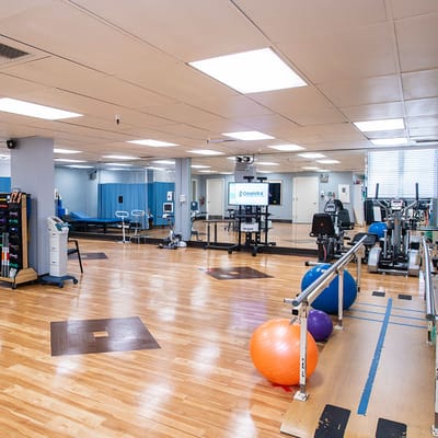 Interior view of a well-equipped therapy room with exercise equipment