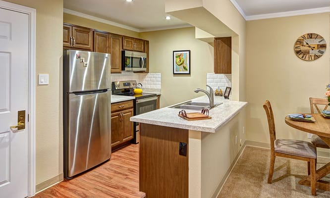 Bright kitchen area with modern appliances and dining space