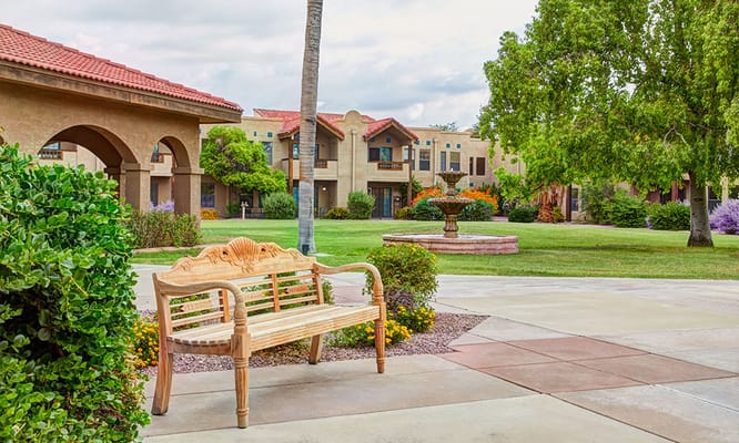 Outdoor area with a bench and landscaped gardens