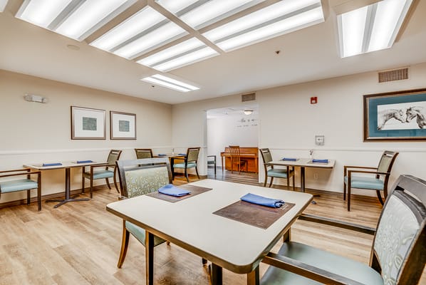 Bright dining area with tables and chairs set up