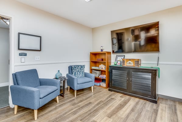 Bright interior lounge with seating and shelves