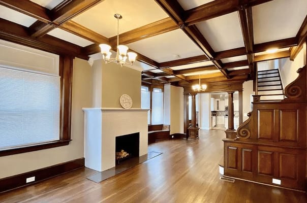 Interior view of a spacious living room with wood accents and a fireplace