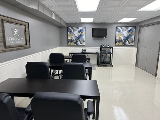 A well-lit activity room with tables and chairs