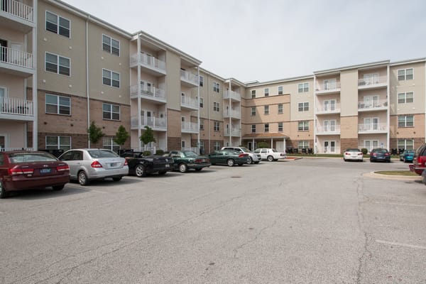Exterior view of Golden Manor Senior Apartments with parking area