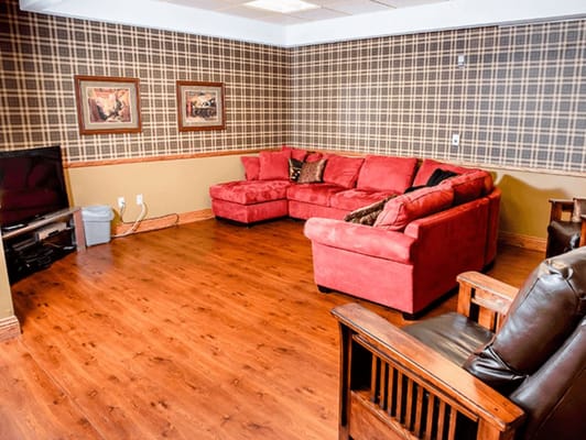 Cozy common area with red couches and decor