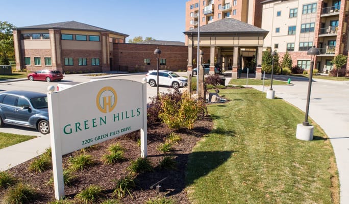 View of Green Hills Retirement Community entrance sign and building